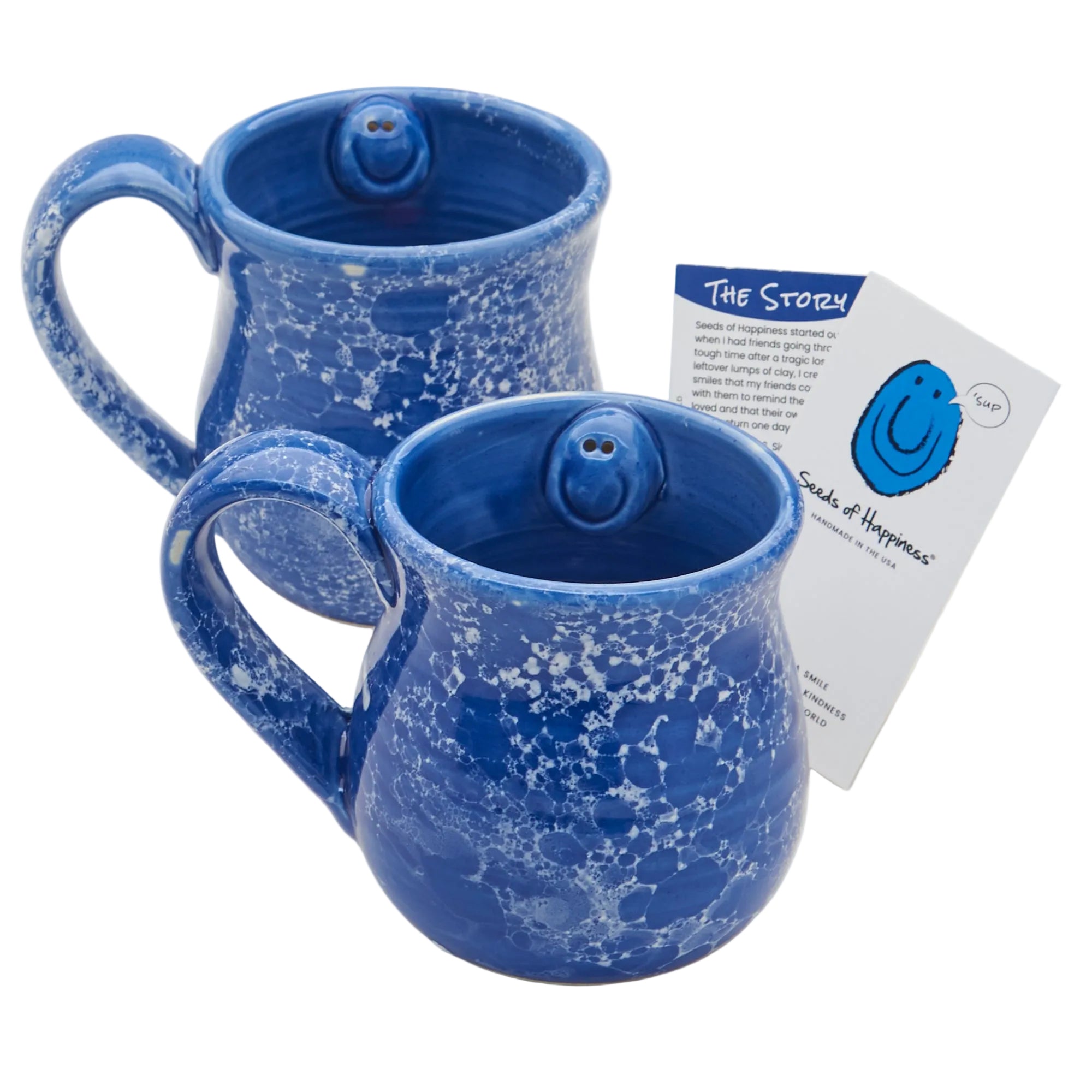 Two blue ceramic mugs with a unique design on a white background