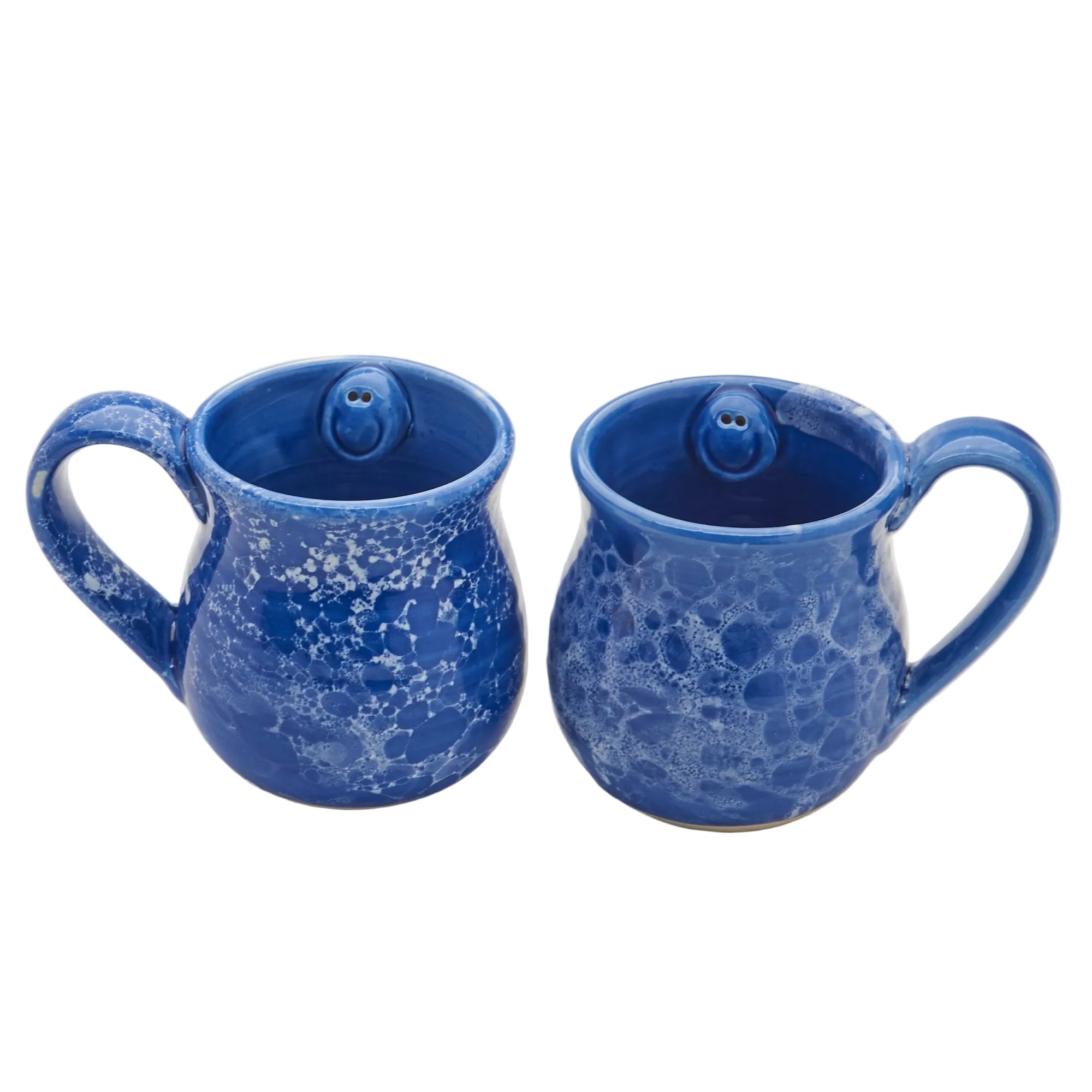 Two blue ceramic mugs with textured surface on a white background