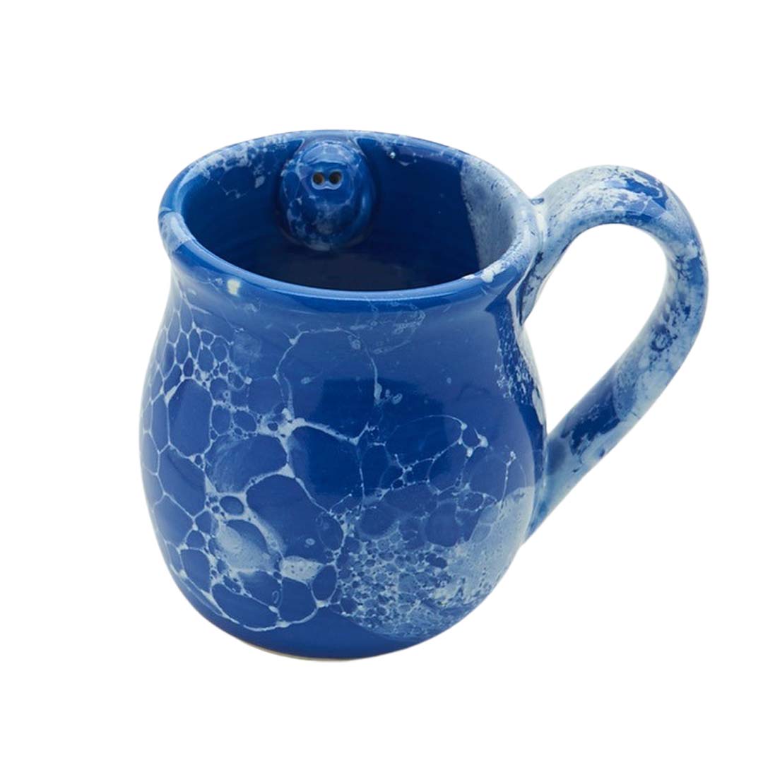 Blue speckled mug with a smiling face on a white background